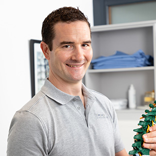 Joe Arkle performs a treatment at Sidmouth Chiropractic Clinic